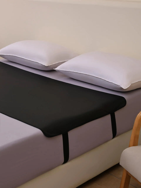 Bedside Grounding Mat For Sleep And Deep Relaxation No Electricity Needed on bed with white pillows and vegan leather surface