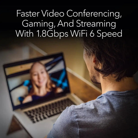 Man using laptop with Nighthawk WiFi 6 USB 3.0 Adapter A7500 AX1800 for faster video conferencing and streaming.