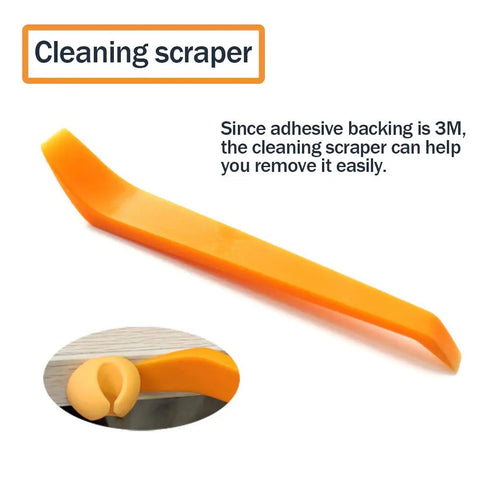 Orange plastic cleaning scraper tool with adhesive tip, easy to remove 3M backing, shown in detail view.