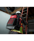 Heavy Duty Canvas Jobsite Backpack With 48 Pockets And Ultra Comfortable Load Bearing Harness Built Like A Tank For Real Deal Contractors And Crew Chiefs Who Want Solid Boss Gear On The Road, worn by a worker climbing a ladder.
