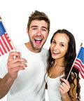 Two people holding Handheld 5x8 Inch American Flags On Wooden Sticks 12 Pack Small US Flags With Safe Spear Tops, smiling