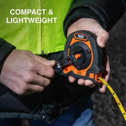 Person using Closed Reel Tape Measure With 100 Foot Nylon Coated Blade Fast Three To One Gear Retracting Smooth Release Button