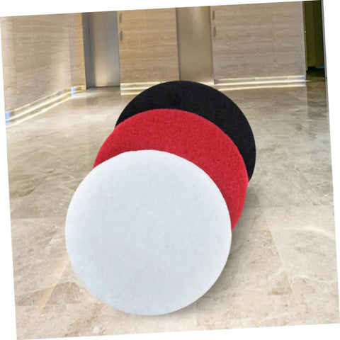 Three colorful floor pads including Five Pack 17 Inch Black Microfiber Floor Cleaning Pads For Polishing Scrubbing And Wax Removal Pro Grade Replacement Pads For Industrial And Commercial Floor Care Machines displayed on marble floor.
