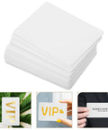 Twenty Piece Bundle Of Slick Blank White Pvc Id Cards With Heavy Duty Waterproof Coating And Hassle Free Printing For Quick Employee Badges And Double Sided Photo Cards In Sharp Resolution arranged in a stack with a thick edge.
