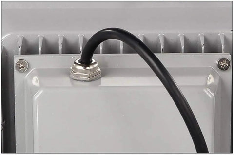 Close-up of black cable connection on back of aluminum 100W LED floodlight with heat dissipation features.