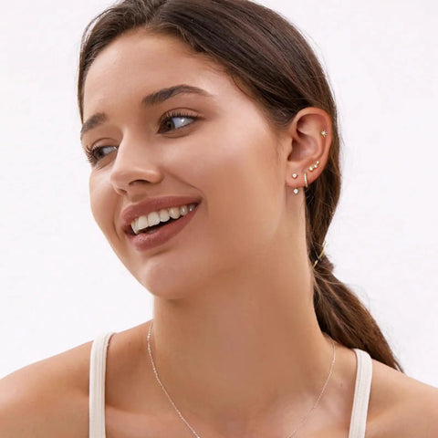 Six Pairs 14K Gold Plated Stud Earrings For Women With Hypoallergenic Cuff Cartilage Styles, Multi Piercing Friendly Dainty Stackable Set, Includes Tiny Hoops And Ball Earrings, Your Go To Gift Jewelry For Everyday Wear, model wearing gold ear stack