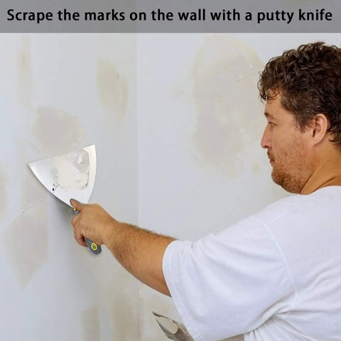 Person using Putty Knife Set 4 Piece Pro Grade Scrapers 6 Inch Heavy Duty Durable CRV Alloy Steel Blades for drywall repair.