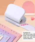 Portable 3 Hole Punch For Scrapbooks And Crafts, gray handheld paper punch with integrated ruler, displayed with multi-hole sheets