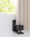 Adjustable Floor Guide For Sliding Barn Doors Black, Wall And Door Bottom Roller Guard, installed on wall, wood door visible