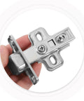 Close-up of Heavy Duty Self-Closing Cabinet Hinges With Hydraulic Soft-Close, silver thickened cold rolled steel, in hand.