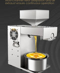 Slick Cold Press Oil Extractor For Nuts And Seeds Fully Automatic Mini Kitchen Machine showcasing golden oil pouring from spout.