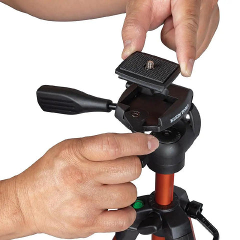 Hands adjusting mount on Lightweight Aluminum Tripod With Mount For Laser Levels And Tools Flexible And Stable On Uneven Terrain