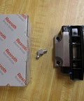 R165129310 Ball Carriage Rexroth Kugelwagen, box, and fastener on wooden surface