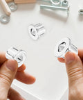 Hands holding stainless steel dowel pin, part of Stainless Steel Dowel Pin Set For Woodworking, Pro Grade Precision Transfer Plugs.