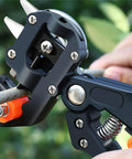 Pro Grade 2-In-1 Grafting And Pruning Tool With Replaceable Omega Cut V Cut And U Cut Blades SK5 Steel Durable ABS Handle In Black And Orange Heavy-Duty Pruner For Precise Grafts And Efficient Garden Pruning, close-up on branch