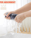 Hands wringing a dark grey 100 Percent Pure Cotton Waffle Weave Dish Cloths 6 Pack Dark Grey Ultra Absorbent Honeycomb Kitchen Towels.
