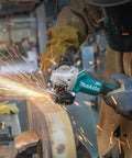 Worker using 18V LXT Brushless Cordless Paddle Switch Cutoff And Angle Grinder for metal cutting with sparks flying