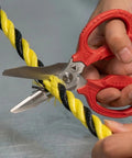 Person using Heavy Duty 6.3 Inch Utility Scissors With 4 in 1 Blade System to cut yellow and black rope. Made in Japan.