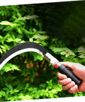 Hand holding Two Pack Short Handle Weeding Sickle Tools Manganese Steel Garden Grass Cutter in garden setting