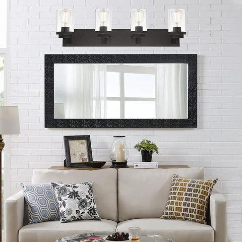 Dope 4 Light Oil Rubbed Bronze Bathroom Vanity Light Wall Sconce With Clear Glass Shades above a decorative mirror in living room