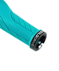 Close-up of turquoise ergonomic mountain bike grip with palm pad and non-slip texture, showcasing lock-on mechanism.