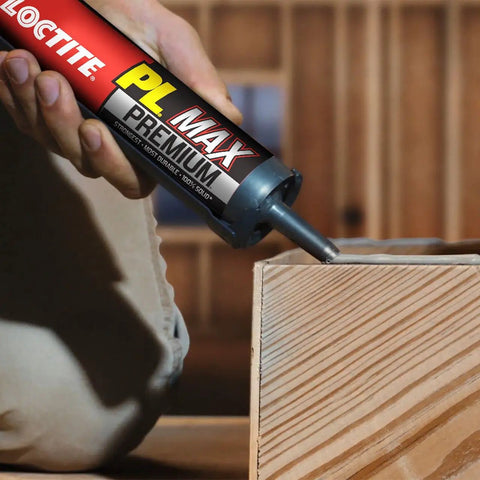 Individual applying Heavy Duty Construction Adhesive For Wood Concrete Stone And More Premium Max Strength Bond That Stays 100 Percent Solid After Curing In A 9 Oz Cartridge 1 Pack to wood surface.