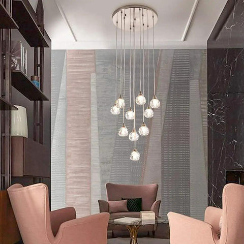 10 Light Stair Crystal Chandelier With Raindrop Globe Glass Ceiling Lighting In Nickel Finish hanging over living room chairs.