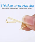 Close-up of a hand holding a hook from the Heavy Duty Picture Hanging Kit With 225 Pieces Of Frame Hooks Nails Hanging Wire Screw Eyes D Rings