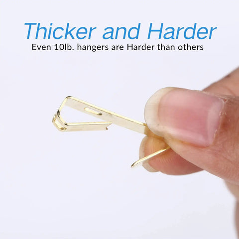 Close-up of a hand holding a hook from the Heavy Duty Picture Hanging Kit With 225 Pieces Of Frame Hooks Nails Hanging Wire Screw Eyes D Rings