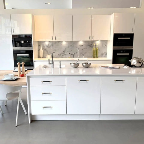 Modern kitchen with white cabinets and stainless steel appliances