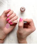 Portable Nail Care Kit With 80 150 240 Grit Sandpaper Discs For Dead Skin Removal, Foot File Sanding Sheets, Grab And Go Travel Friendly Nail And Foot Grooming Set For Home Or On The Go. close-up of hands using pink nail file