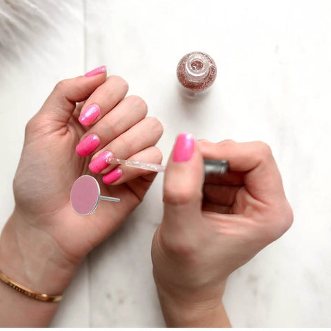 Portable Nail Care Kit With 80 150 240 Grit Sandpaper Discs For Dead Skin Removal, Foot File Sanding Sheets, Grab And Go Travel Friendly Nail And Foot Grooming Set For Home Or On The Go. close-up of hands using pink nail file