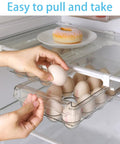 Fridge Egg Holder Drawer Organizer For Easy Egg Storage In Your Refrigerator And Mini Fridge Pull Out Tray Fits Shelves Under 0.6 Inches Keeps Eggs Fresh And Doubles As A Small Fruit And Veggie Keeper being pulled out by hand.