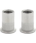 Close-up of two 304 stainless steel flat knurled M6 rivet nuts, part of the 25 Pack M6 Rivet Nut Threaded Inserts in 304 Stainless Steel Flat Knurled Rivnuts with Deep Threads for Strong Grip Easy Install Heavy Duty Bulletproof Fasteners for Auto Marine and DIY Projects.