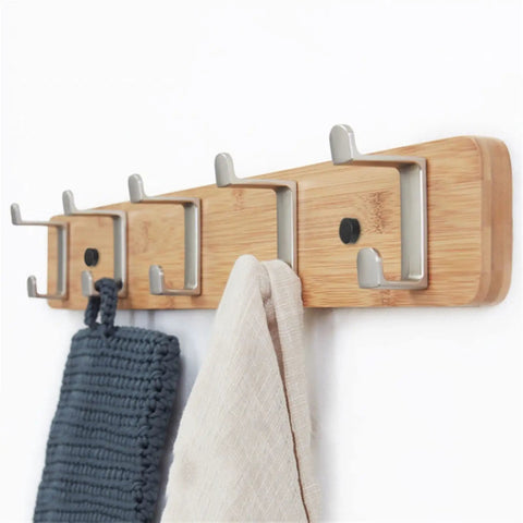 Slick Modern Wall Mounted Coat Rack In Brushed Brass With Heavy Duty Hooks For Entryway Living Room Or Kitchen To Hold Jackets Bags Hats And Umbrellas No Fuss Ever Durable Finish Looks Sharp While Sorting Daily Items Straight Up with towels hanging.
