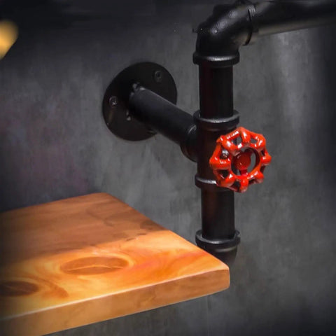 Close-up of industrial iron pipe wine rack for home bar flex with red valve and wooden shelf detail, heavy duty storage solution.