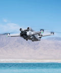 Ultra Light Mini 3 Pro Drone With 4K Video And 48MP Photos flying over a lake with mountains in the background, showing its aerial capabilities.