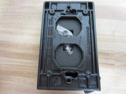 12-In-1 Universal Weatherproof Metal Flip Cover for 1-Gang Outlets showing back view with mounting holes and screw details.