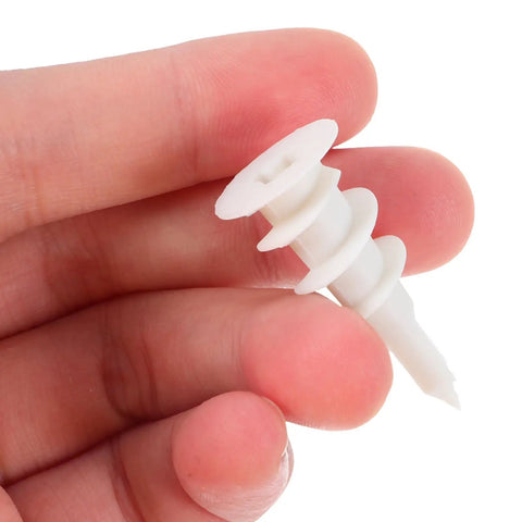 Person holding a self drilling drywall anchor from the Self Drilling Drywall Anchors And Screws Kit, 20 Sets, heavy duty nylon and iron expansion anchors