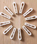 10 Pack Vacuum Bag Clips With Sliding Grip For Tight Seals, arranged in a circle on a wooden surface. Reusable and airtight.