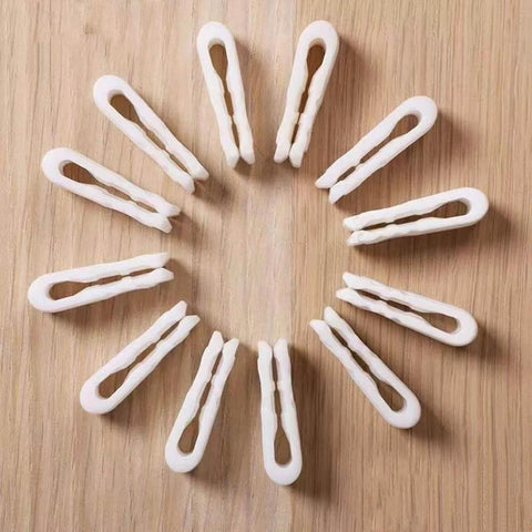 10 Pack Vacuum Bag Clips With Sliding Grip For Tight Seals, arranged in a circle on a wooden surface. Reusable and airtight.