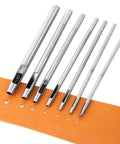 7 Piece Hollow Punch Set With Round Holes From 0.5mm To 5mm For Leather Craft Watch Bands And More displayed on orange leather