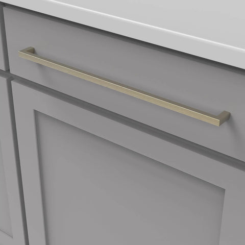 Beefy Solid Core Cabinet Pulls With 18 Inch Center Elusive Golden Nickel Finish Skylight Collection installed on a gray cabinet