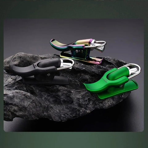 Three Cannon Surf Fishing Trigger Aids for Sea Casting in black, multicolor, and green on a rock display