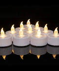 Battery Operated LED Tea Light Candles 24 Pack Flameless Flickering Warm White arranged in a glowing cluster