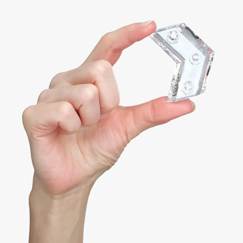 Hand holding clear acrylic piece of Dope Clear Acrylic Skateboard Wall Mount Hanger For Display And Storage Of Decks And Longboards.