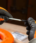 Non-conductive fish tape repair kit; white tape with black connector, held by orange-gloved hands.