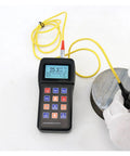 Top Shelf Digital Hardness Tester Portable Handheld Metal Gauge measuring hardness of a metal sample using a probe.