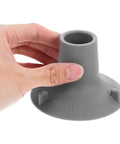 Non Slip Shower Chair Foot Caps 12 Pack Heavy Duty TPR Pads held by hand, close-up view showing 'Pull Tab to Release' text