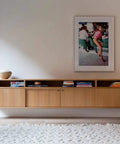 Contemporary living room with mounted cabinet and artwork on wall, featuring White Oak Rift Wood Veneer Sheet 24x48 Peel And Stick A Grade Veneer Face